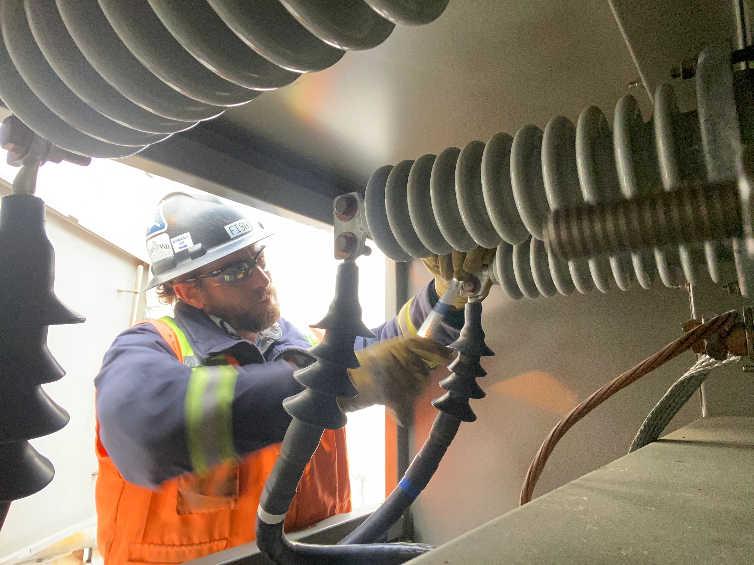 Electrician working on industrial electrical equipment