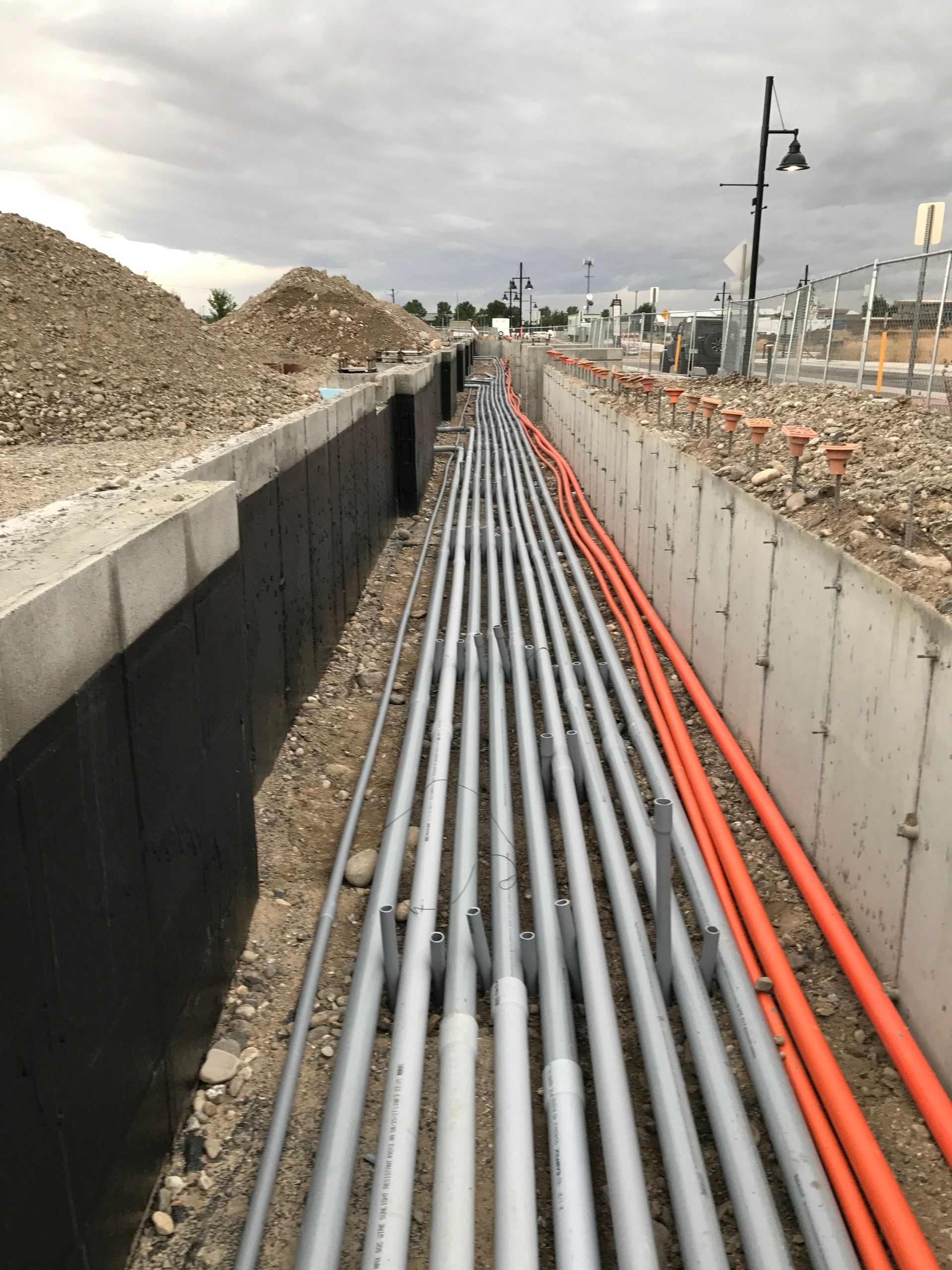 Utility conduit installation at construction site